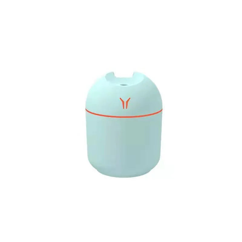 Mini round aromatherapy diffuser in ivory white with USB cable and essential oil bottle