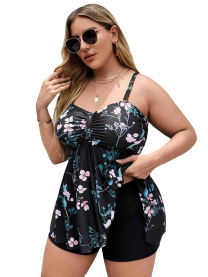 Women's one-piece swimsuit with a split colour floral print, shown on a mannequin.