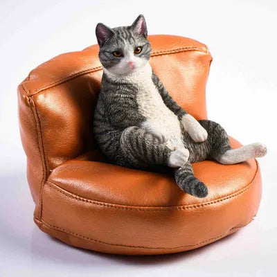 Lazy cat ornament on miniature sofa for car dashboard decoration, 7.5cm high with fabric art detailing
