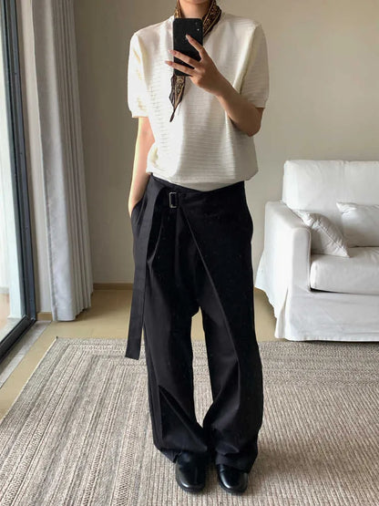 Black straight-leg trousers with an adjustable mid-waistband and single pleat detail on a hanger.