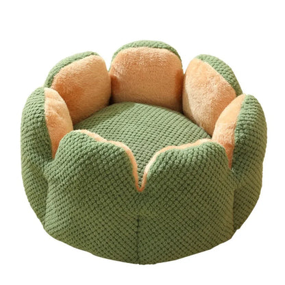 Green cactus petal shape pet bed for cats and dogs on a hardwood floor.