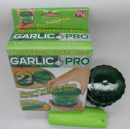 Green manual garlic peeler kitchen tool with silicone roller and plastic press handle.