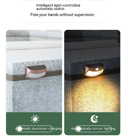 Solar outdoor wall lamp with smiling face design measuring 153mm × 76mm × 38mm for garden lighting