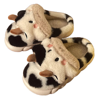 White cow-themed plush slippers with a non-slip textured sole for women.