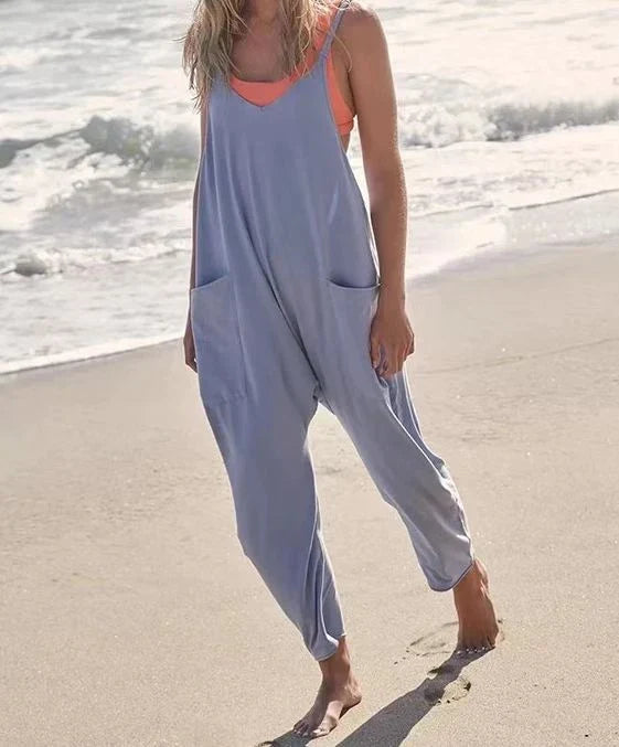 Sleeveless jumpsuit with spaghetti straps, pockets, and zipper closure in various colors