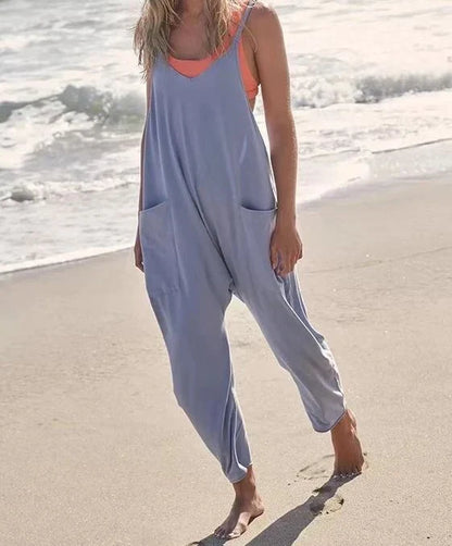 Sleeveless jumpsuit with spaghetti straps, pockets, and zipper closure in various colors