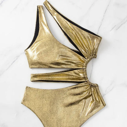 Women's gold one-piece swimsuit with backless design and spandex material
