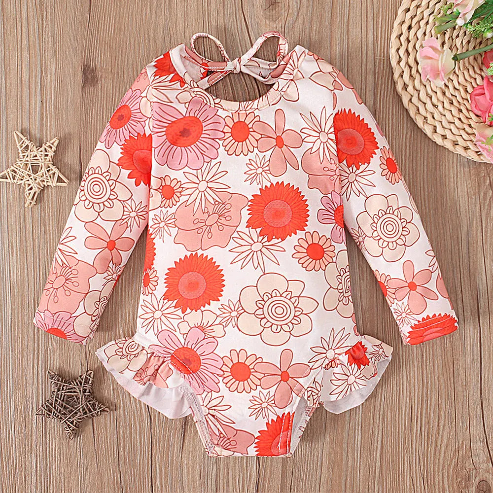 Girl's floral print swimsuit with crew neck and open back design in polyester fabric