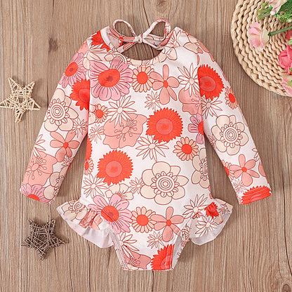 Girl's floral print swimsuit with crew neck and open back design in polyester fabric