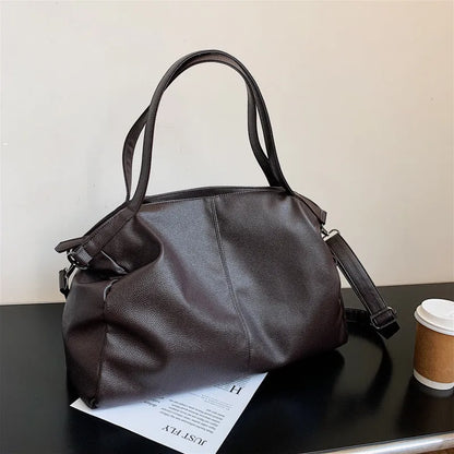 Large soft black PU messenger bag with long shoulder strap and front car suture detailing