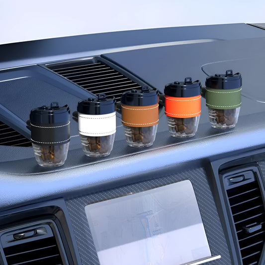 Brown plastic coffee cup-shaped solid car air freshener for dashboard odour removal.