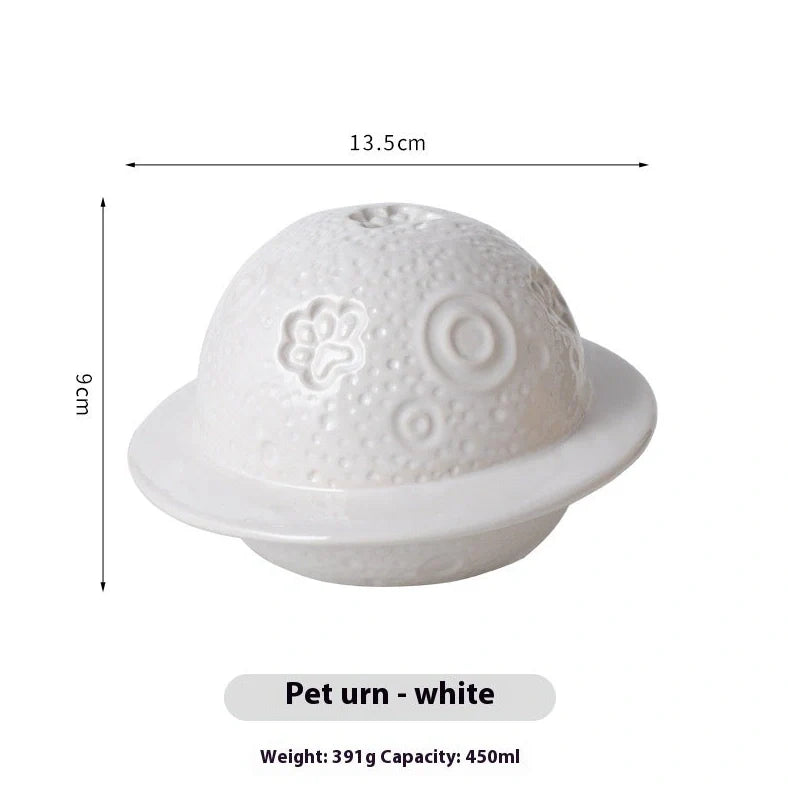 Handmade ceramic cinerary casket with cosmic starry sky design and cat-dog motifs in multiple colours