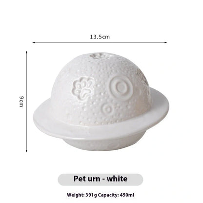 Handmade ceramic cinerary casket with cosmic starry sky design and cat-dog motifs in multiple colours