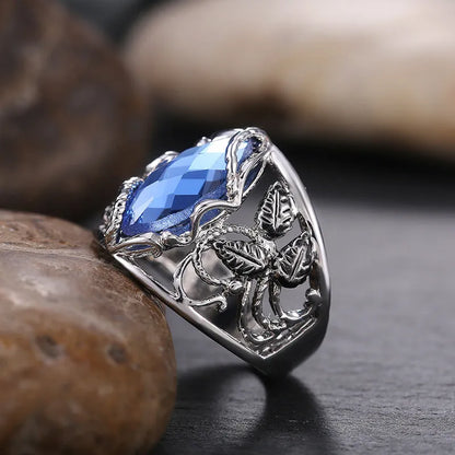 Blue horse eye-shaped women's alloy ring with crystal inlay on a white background.