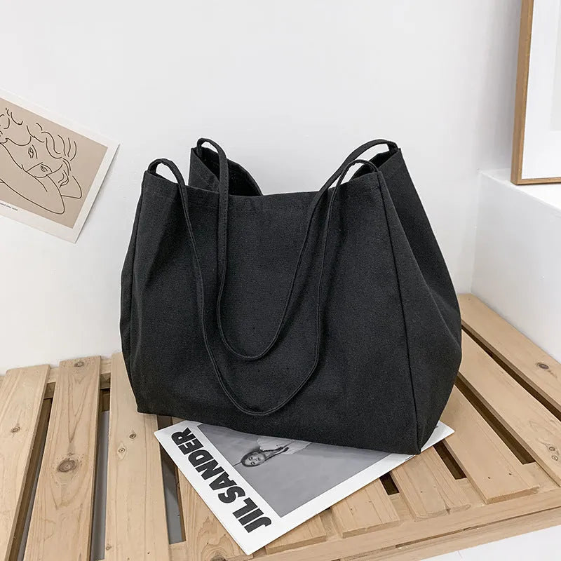 Solid colour women's canvas handbag with double shoulder straps showing internal mobile phone compartment