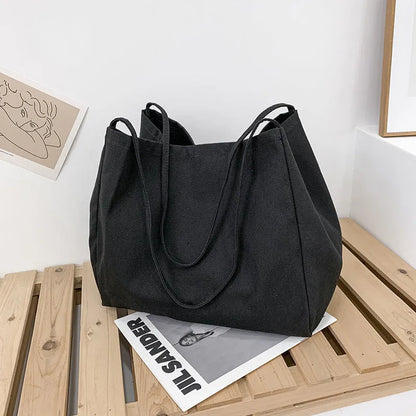 Solid colour women's canvas handbag with double shoulder straps showing internal mobile phone compartment