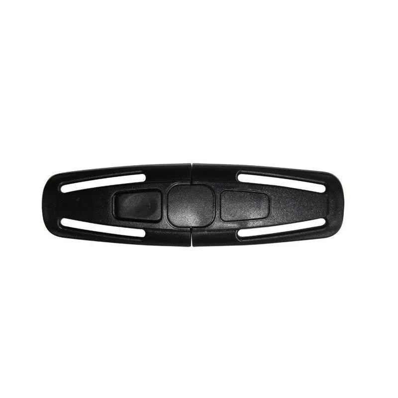 Black nylon child safety seat chest clip with lock button for 5-point harness, shown next to a ruler for scale.
