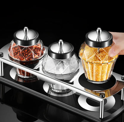 Glass seasoning jar with spoon cover for solid spices like salt and pepper on kitchen counter