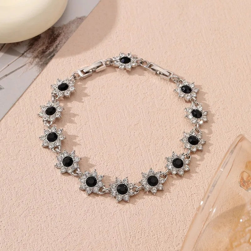 Floral shaped zinc alloy bracelet with electroplated colourful gem finishes in gold and silver tones.