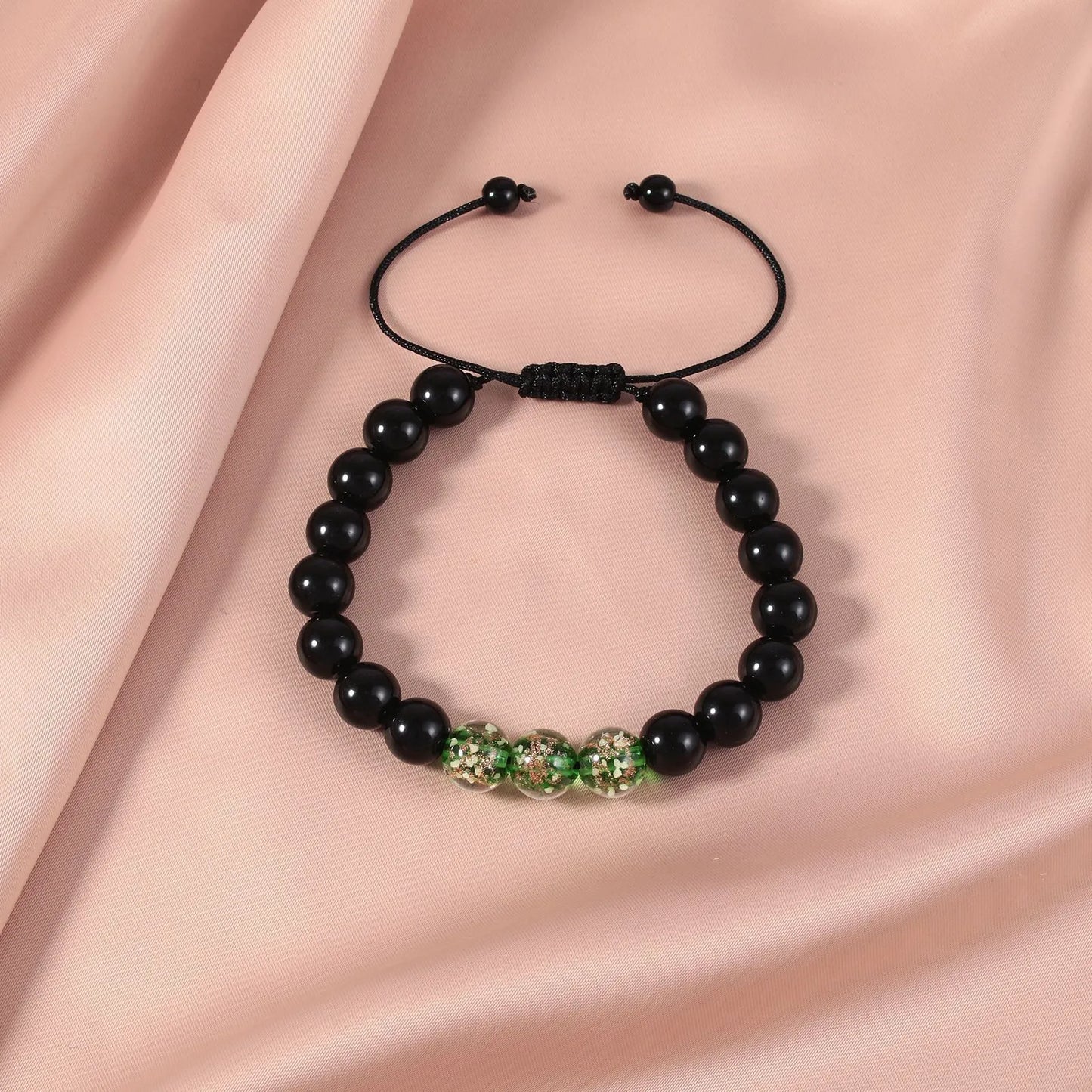 Adjustable bracelet with luminous geometric glass beads in six colour options on a wrist