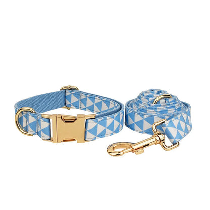 Blue cloth dog collar, leash, bow, and vest four-piece set with triangular metal ring, shown in a pet accessory bundle.