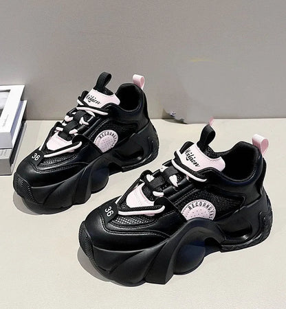 Women's pink sneakers with cross straps, thick sole, and mesh lining on a white background