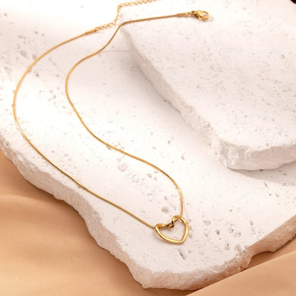 Stylish titanium steel heart pendant necklace with unique twist design, available in gold and silver colors