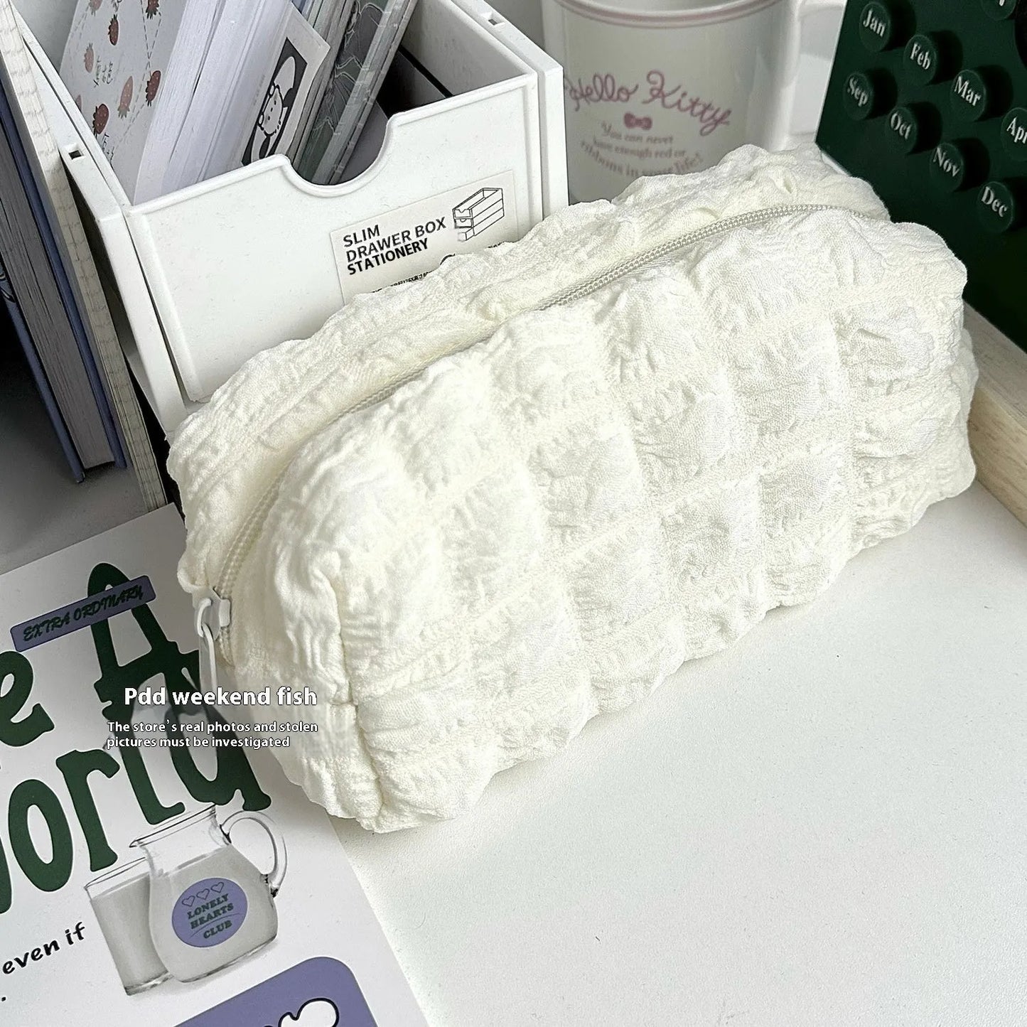 Beige and black fabric pencil case with padded cream puff design measuring 20cm length