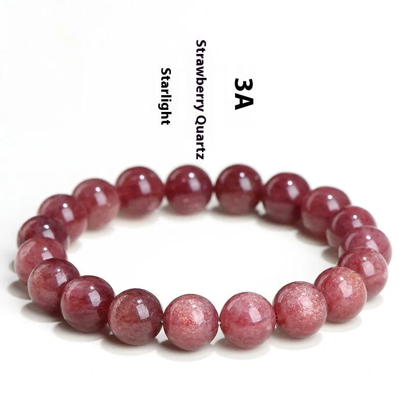 A polished strawberry quartz crystal bracelet in cherry red on a white background, showing geometric beads.