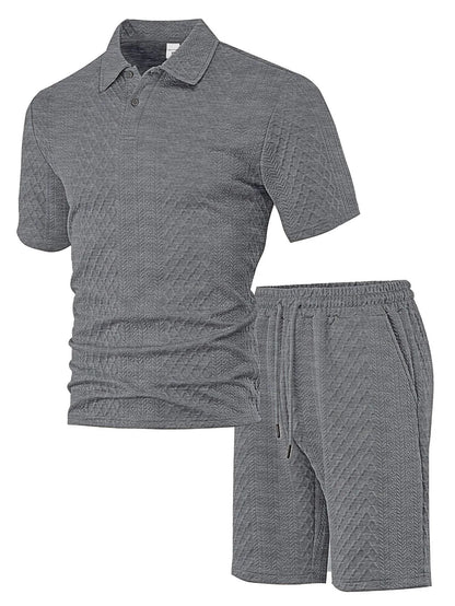 Men's patterned cloth casual suit set with short sleeve polo top and trousers on a hanger.