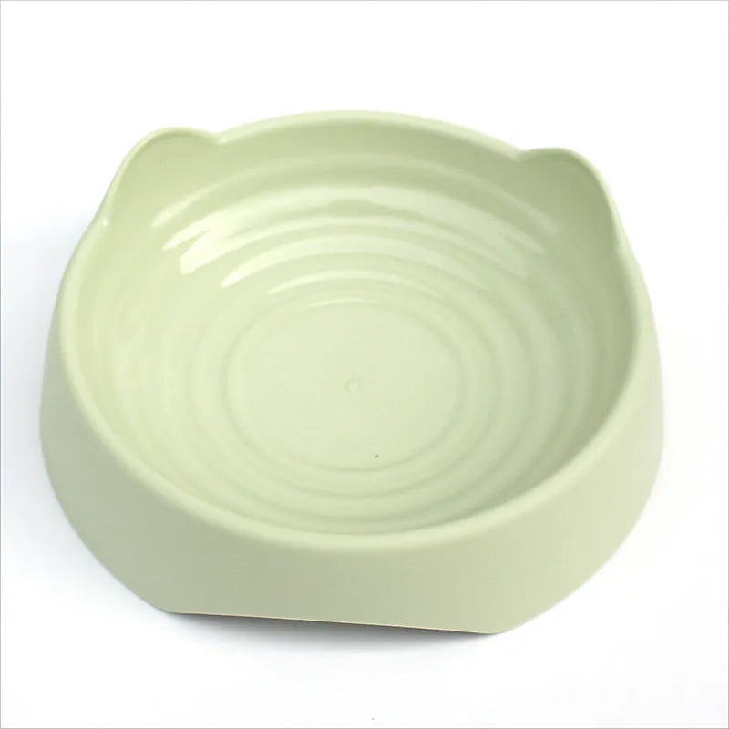 Blue ceramic dog slow feeder bowl with maze of cups for slowing fast eaters, shown on wooden floor.