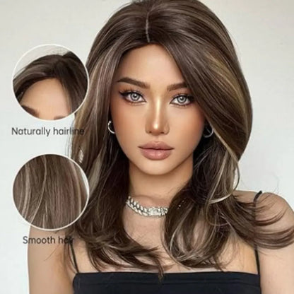 Mid-length curly synthetic wig with long bangs in a platinum gradient colour, shown on a wig stand.