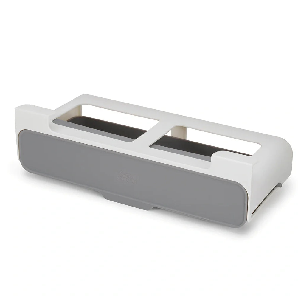 White plastic hanging spice rack with six clear glass bottles, mounted on kitchen door for punch-free storage