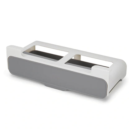 White plastic hanging spice rack with six clear glass bottles, mounted on kitchen door for punch-free storage