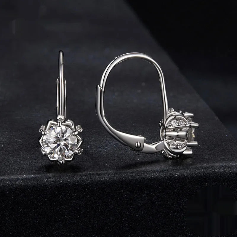 Sterling silver flower bud ear clips with white gold plating and moissanite centre stone