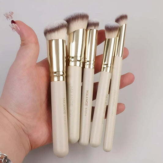 Apricot-coloured angled blush makeup brush and kabuki brush from a 5-piece synthetic bristle set.