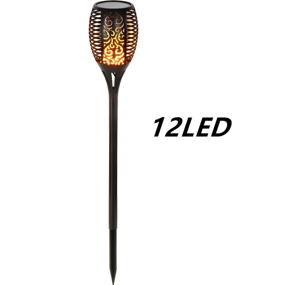 Solar garden LED light with flame flickering effect on stainless steel stake in outdoor setting