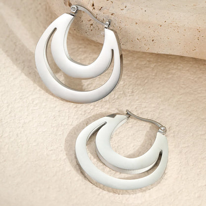 Geometric metallic French earrings in gold or steel colours with round ring design elements