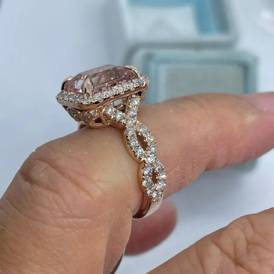Rose gold electroplated geometric alloy ring on a white background.