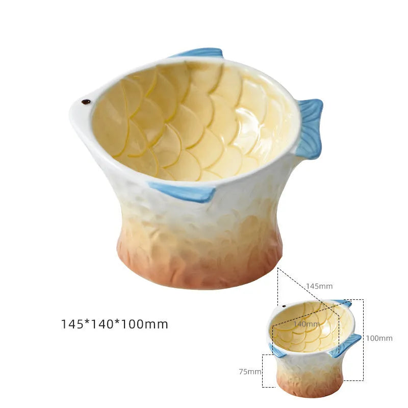 Set of four blue fish-shaped ceramic cat bowls with tilted design on a wooden table