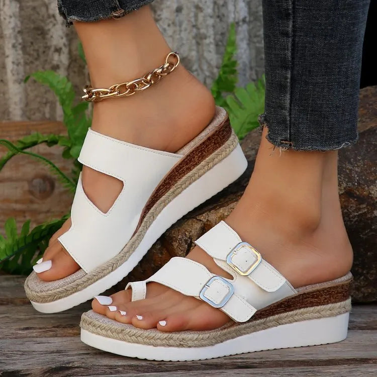 White patent leather wedge sandals with peep toe and finger fit design