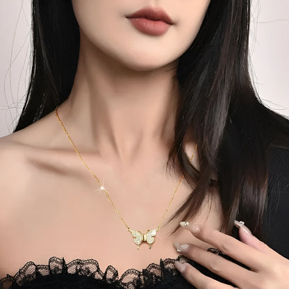 Gold titanium steel clavicle chain necklace with a magnetic butterfly pendant on a twisted chain.