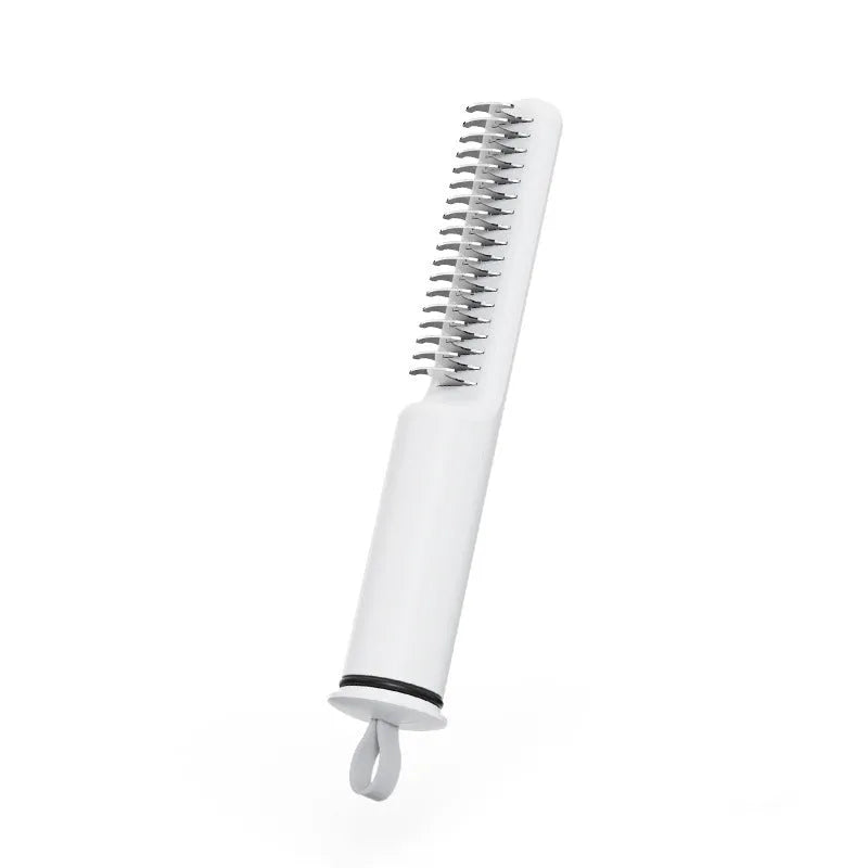 Stainless steel dog dematting comb with ergonomic handle, shown in pink colour on a white background.