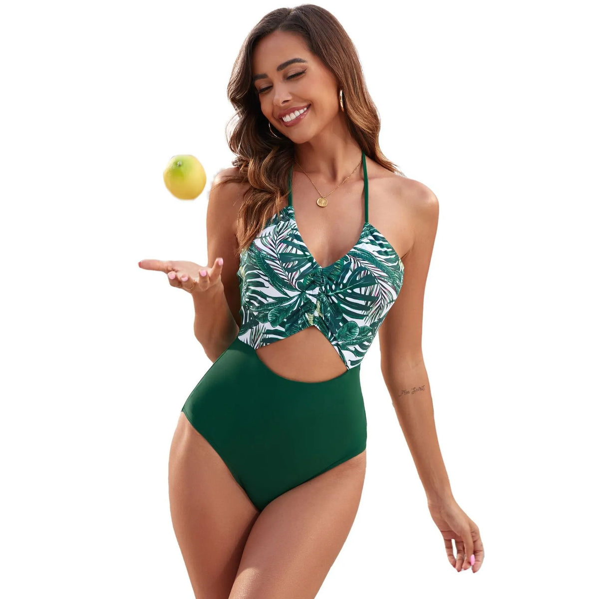 Women's one-piece swimsuit with a printed patchwork leaf design in black.