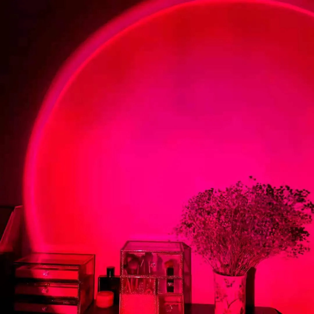Rechargeable rainbow and sunset projection lamp with USB cable and push-button switch.