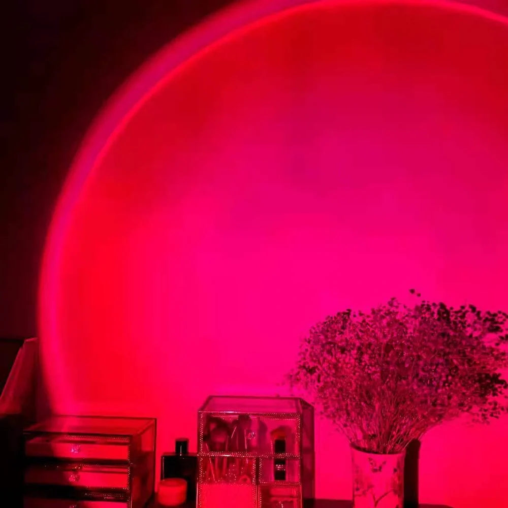 Rechargeable sunset projection lamp showing red and rainbow colours on wall