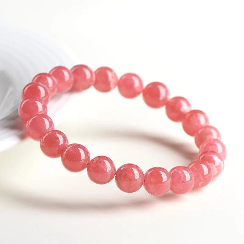 Women's geometric crystal bracelet with red rhodochrosite stones and longevity lock clasp, showing bead size options