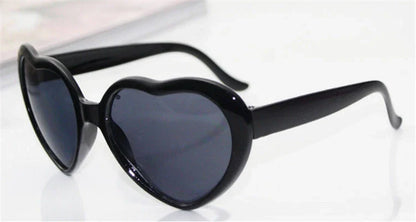 Stylish heart-shaped lighting sunglasses with a plastic frame and resin lenses, creating a mesmerizing effect for romantic occasions