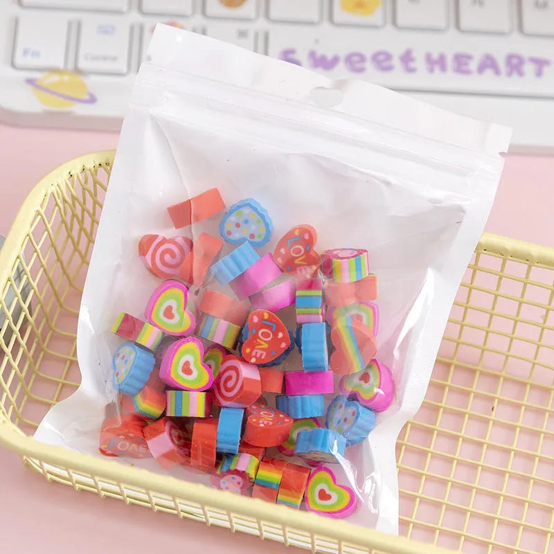 Assortment of 50 small cartoon erasers in pearlescent bags, showing fruit, animal, and holiday designs.