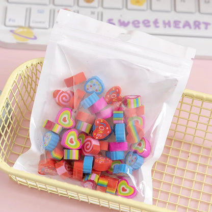 Assortment of 50 small cartoon erasers in pearlescent bags, showing fruit, animal, and holiday designs.